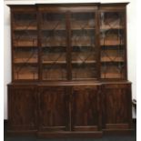 Large mahogany break front dresser/display case with glazed upper section. Splits into two