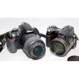 Nikon Coolpix 8800 digital camera c /w a NikonD3100 DSLR with 18-55mm kit lens fitted. Both