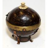 A coconut shell box with bone finial and brass and copper mounts.