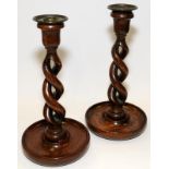 Pair of Victorian oak open barley twist stem candlesticks. 27cms tall