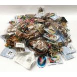 Plastic tub containing a large collection of costume jewellery.