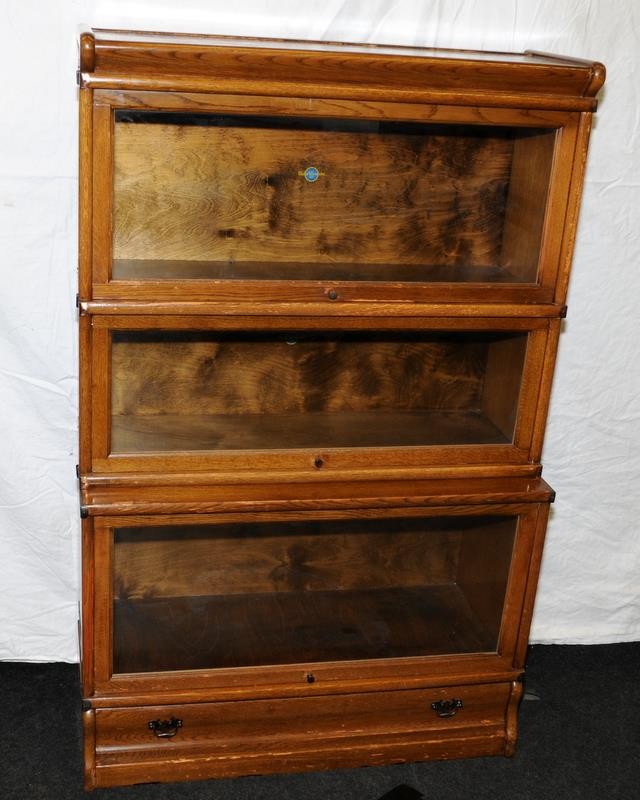 Globe Wernicke oak book case with three glazed doors above a drawer. 86.5cm (W), 35.5cm (D),