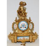 Antique French ormolu striking mantel clock featuring hand painted porcelain panels with a cherub