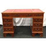 Mahogany three section pedestal writing desk with red leather top, includes keys. 77x121x62cm.
