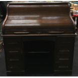 Antique oak roll top pedestal desk fitted with seven drawers 125x122x76cm.