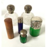 Assorted silver topped bottles and two others.