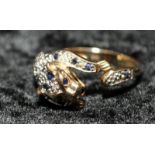 A leopard 9ct gold ring set with diamonds and sapphires, Size O