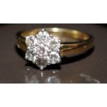 An 18ct gold Diamond daisy ring approx 0.80 points, Size M.