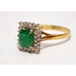 An emerald approx. 1.00ct with diamond surround set in 18ct gold ring Size Q