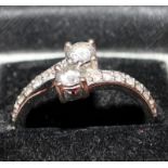 An 18ct white gold Diamond ring, two diamond solitaires approx. 0.25pts each and two rows of