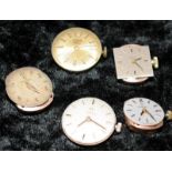 One Tudor and four Omega watch movements. All bar one seen working