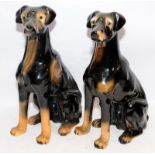 Pair of large glazed ceramic seated dogs, one a/f. Approx 40cms tall