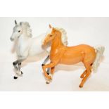 Pair of Beswick prancing horses, a Palomino and a Grey, 18cms tall