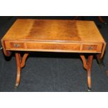 Quality walnut veneer sofa/games table with extending drop sides. On outswept reeded legs with brass