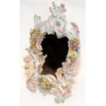 A decorative Sitzendorf easel mirror featuring flowers and cherubs. 30cms tall