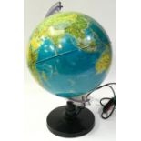 An illuminated world globe of the world 82cm diameter 43cm tall.