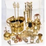 A collection of vintage brassware to include a fireside companion set and a desktop cannon