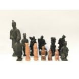 A collection of oriental figurines to include terracotta warrior figures and carved stone