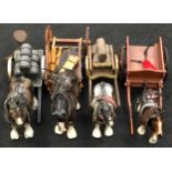 Collection of four vintage ceramic shire horse figurines with carts together with a cast metal