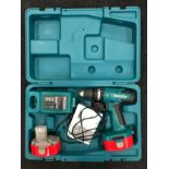 Makita drill with battery and charger in case.