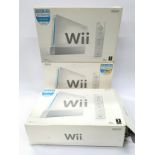 Three boxed Nintendo Wii consoles to include accessories and power supplies.