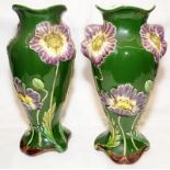 pair of antique Art Nouveau majolica vases with applied flower decoration on dark green ground.