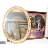 A wall mirror in a gilded oval frame, 68cms across widest point c/w framed mirrored wall art