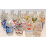 A collection of vintage advertising glass milk bottles