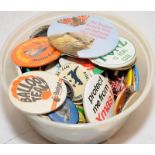 Small tub of vintage advertising pin badges