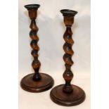 A pair of antique oak barley twist candlesticks 31cms tall