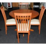 Circular extending table by Morris Furniture Co. c/w with four upholstered dining chairs. 140cms