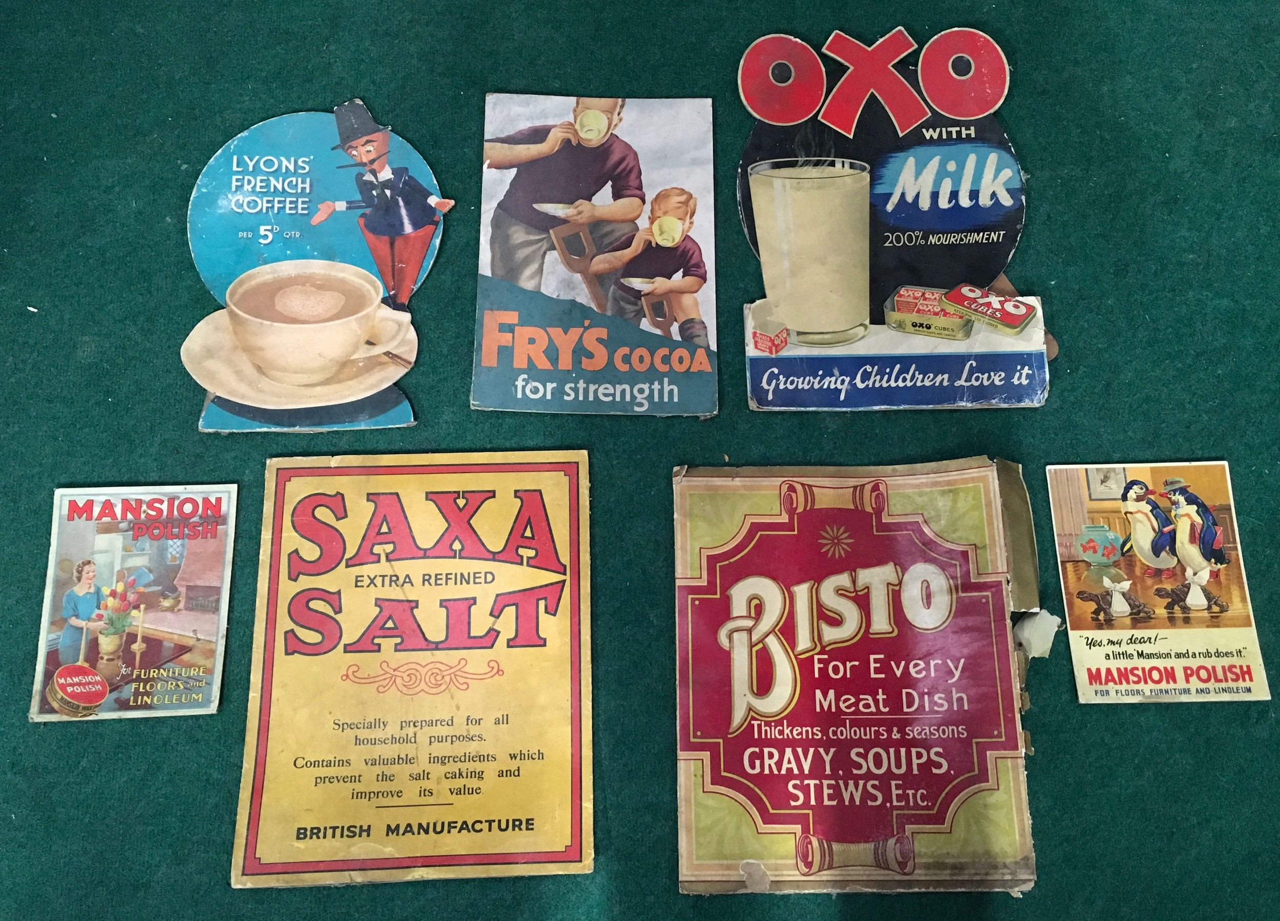 Various vintage advertising signs to include OXO, Bisto and Saxa Salt.
