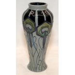 Moorcroft Pottery baluster vase in the Peacock pattern on a grey ground. Standing 21cms tall