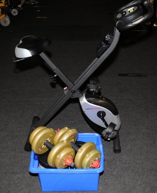 A collection of weights and an Ultra sport exercise bike.