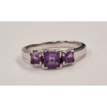 A 925 silver and amethyst three stone ring Size R (D9)