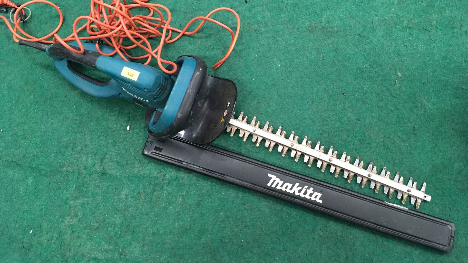 A Makita electric hedge trimmer.