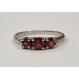 A 925 silver and natural garnet three stone ring Size O (d7)