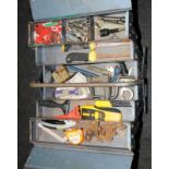 A metal tool box containing various tools. (D5)