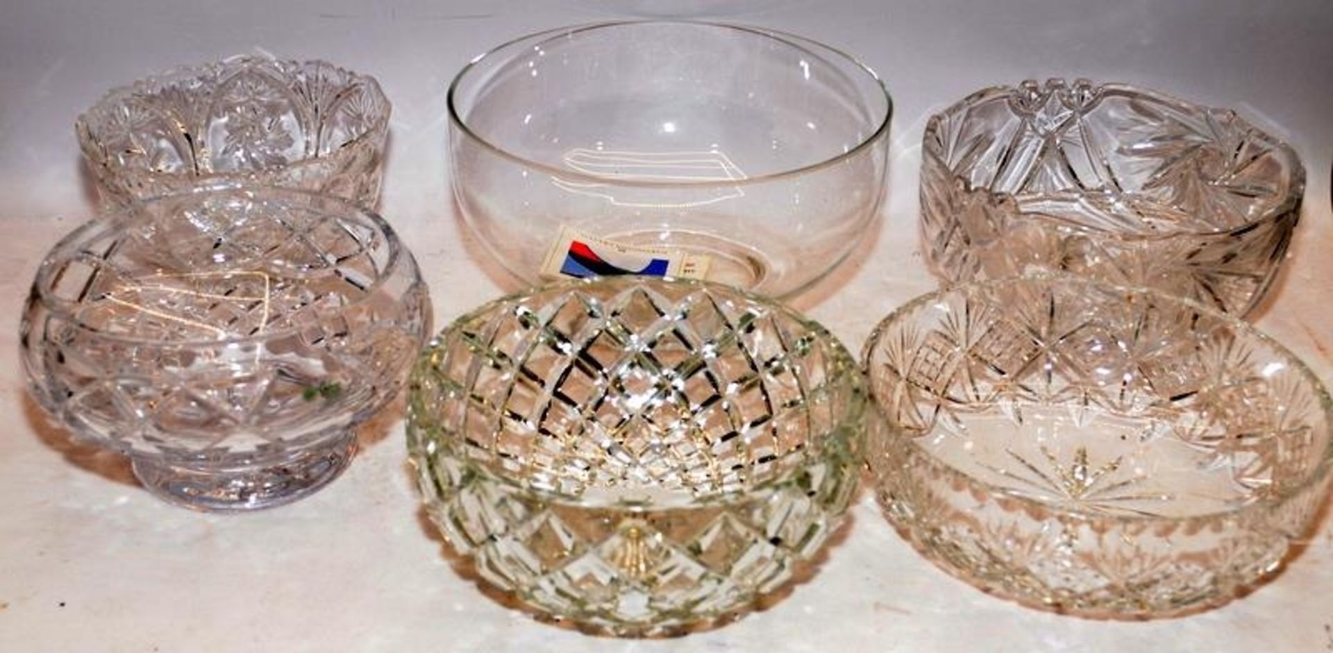 A collection of large cut glass lead crystal fruit bowls, the largest being 25cms across x 14cms