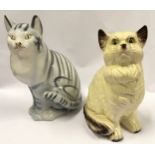 A pair of ceramic sitting cat figurines the largest measuring 34cm.