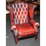 Vintage red leather chesterfield wingback armchair. With signs of wear. Seat height approx 46cms