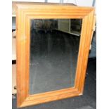 Substantial bevelled edge mirror in a pine frame. O/all size 84cms x 112cms