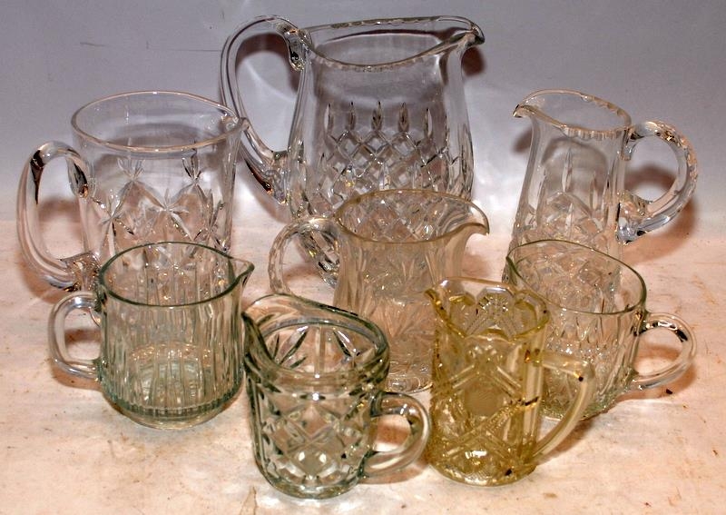 A collection of cut glass lead crystal jugs, the largest being 18cms tall. 8 in lot
