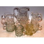 A collection of cut glass lead crystal jugs, the largest being 18cms tall. 8 in lot