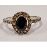 A 925 silver halo style ring with dark centre stone Size Q (c2)