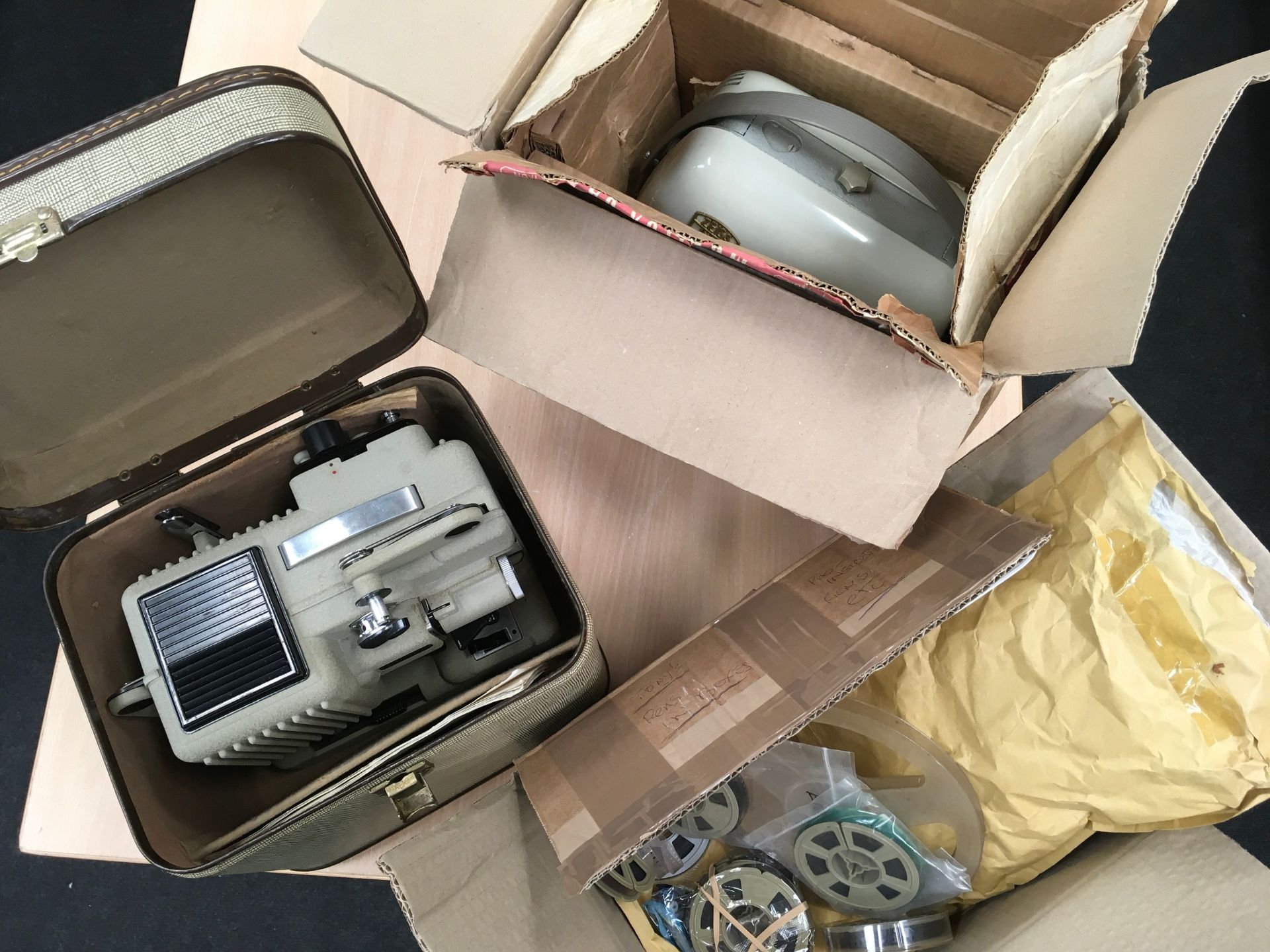 Zeiss Ikon Movilux film projector c/w another. Lot also includes a number of unviewed 8mm home