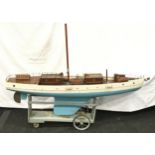 Antique very large wooden pond yacht on wheeled stand 135cm long.