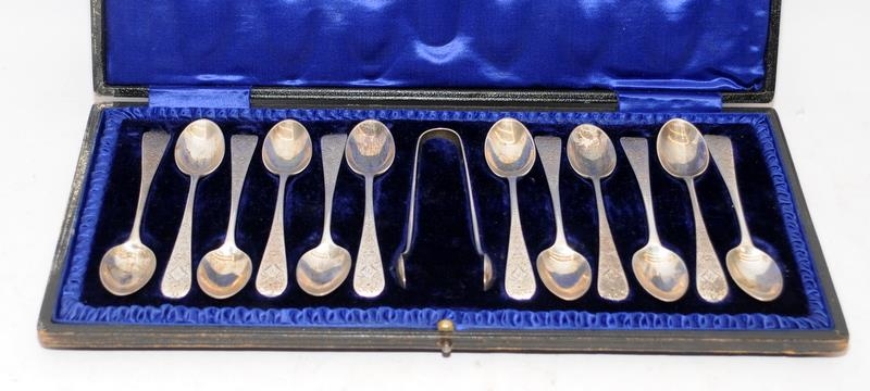 Set of 12 sterling silver teaspoons c/w a pair of tongs, hallmarked for Sheffield 1903. Offered in