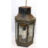 Antique outdoor wall lantern of brass and glass construction converted with electric fitting.