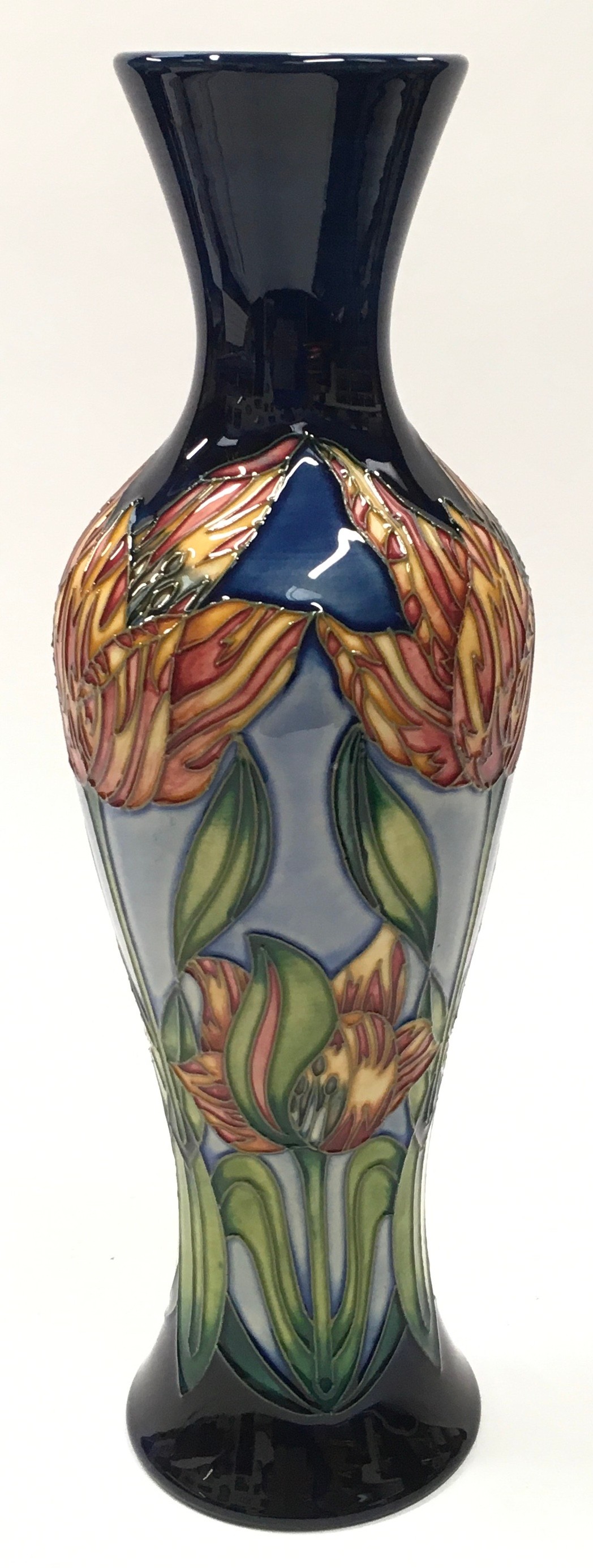 Moorcroft tall navy vase decorated with orange flowers 2001. 31cm tall. Signed and marked to base.